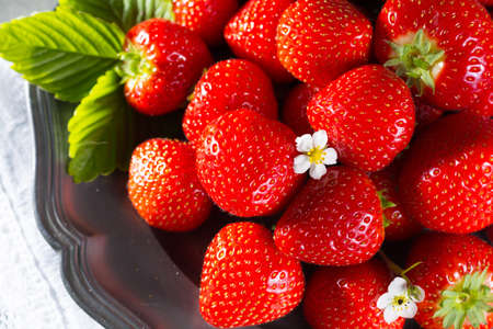 Fresh ripe strawberry. Red strawberry and blossom. Strawberry Juice. Loosely laid strawberries in different positions.の写真素材