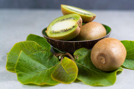 Tropical ripe organic sweet green kiwi fruit with leaves ready to eatの写真素材