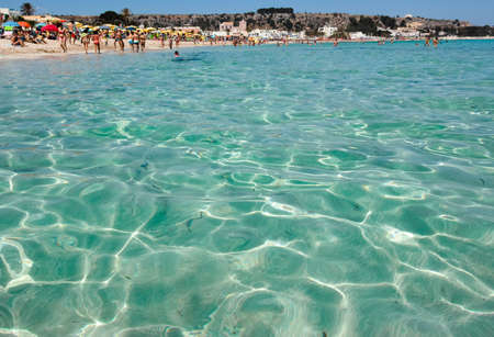 Crystal clear sea water texture with glare from the sunの写真素材