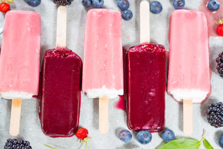 Fresh summer wild blueberries and  brambleberry, strawberry and home made ice cream popsicles.の写真素材