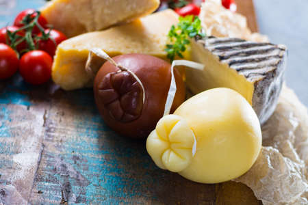 Traditional Italian hard cheeses Parmesan, Grana Padano, Pecorino, Caciocavallo, Provolone  on wooden plateの写真素材