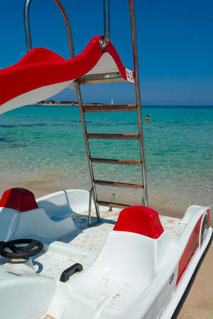 Colorful pedal-boats with water slides on the beach.の写真素材