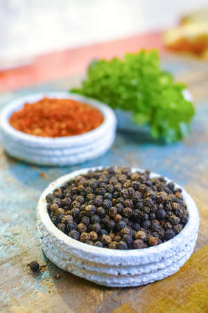 Red hot chili Cayenne and black pepper fresh and dried powdered spice, ready to use on wooden backgroundの写真素材