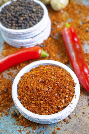 Red hot chili Cayenne and black pepper fresh and dried powdered spice, ready to use on wooden...