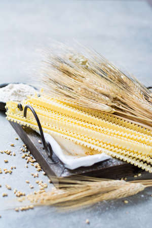 Organic ingredients for pasta preparation - flour from hard wheat grano duro, wheat ears and dried pastaの写真素材