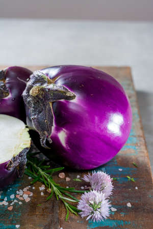 Violet eggplant, fresh healthy vegetables on wooden plankの写真素材