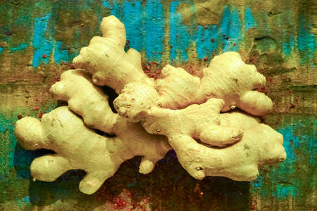 Fresh organic ginger root with powdered Cayenne pepper on the wooden table, used food ingredient and for medicine.の写真素材