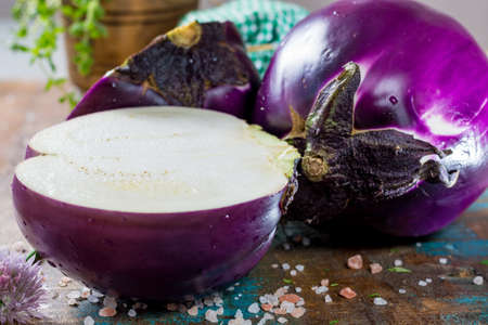 Violet eggplant, fresh healthy vegetables on wooden plankの写真素材