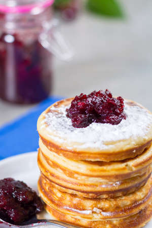 Homemade American pancakes served with red cranberry jam on blue napkin, Americal flag colors, American style breakfastの写真素材