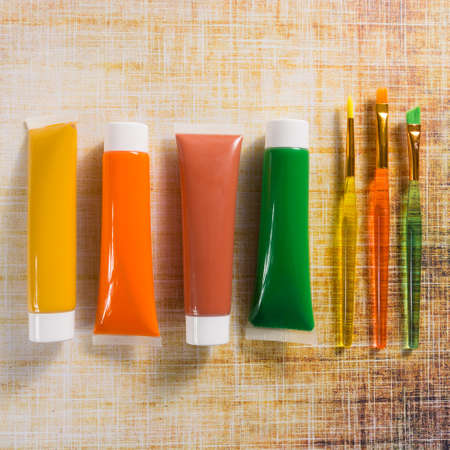 Colours of the nature - mix of green, yellow and brown - home or office interieur design concept, tubes with acrylic paint and  brushes, close upの写真素材