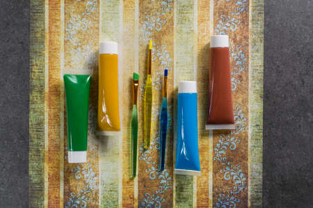 Colours of the nature - mix of green, blue, yellow and brown - home or office interieur design concept, tubes with acrylic paint and  brush, close upの写真素材