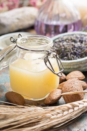 Nature cosmetics, handmade preparation with essential oils and ancient minerals of  parfums, skincare, creams, soaps from fresh and dried lavender flowers, roses, wheat, almond nuts, green clay powder in French artisanal boutique home style, top viewの写真素材