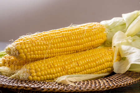 Fresh yellow ripe sweet raw corn on rustic wooden table, closeupの写真素材