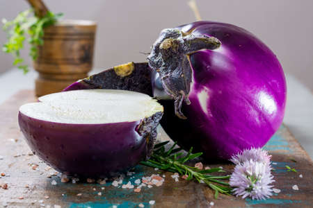 Violet eggplant, fresh healthy vegetables on wooden plankの写真素材