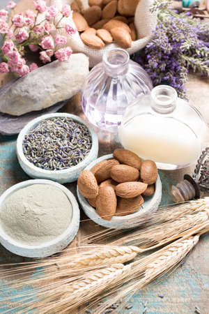 Nature cosmetics, handmade preparation with essential oils and ancient minerals of  parfums, skincare, creams, soaps from fresh and dried lavender flowers, roses, wheat, almond nuts, green clay powder in French artisanal boutique home styleの写真素材