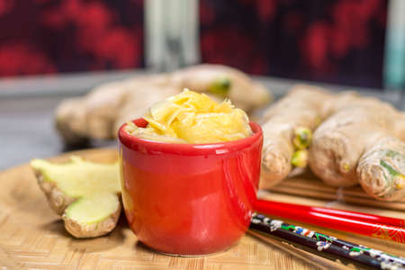 Red bowl of delicious fresh pickled sushi ginger, ready to eat, asian food conceptの写真素材