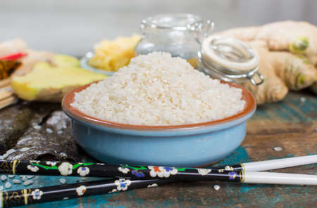 Asian food background. Sushi and rolls preparation. Making sushi at home traditional sushi ingredients - ginger, rice, vinager,の写真素材