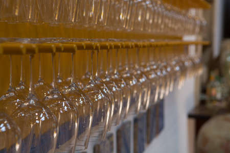 Empty wine glasses in row on bar, restaurant, wine tasting on wineryの写真素材