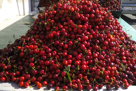 New harvest of fresh ripe red sweet cherry, street market in Italy, Sicilyの写真素材