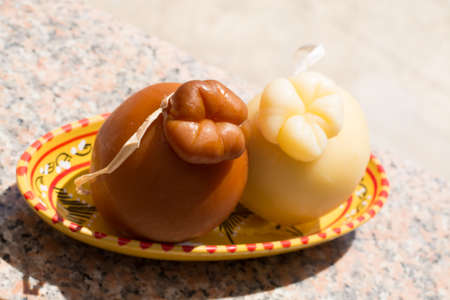 Traditional Italian hard cheese Provolone of Caciocavallo, white and smoked, ready to eatの写真素材