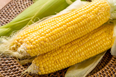 Fresh yellow ripe sweet raw corn on rustic wooden table, closeupの写真素材