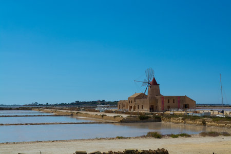 Sea salt production , salt wind mills are seen in suburbs of Marsala, Sicily, Italy.のeditorial素材