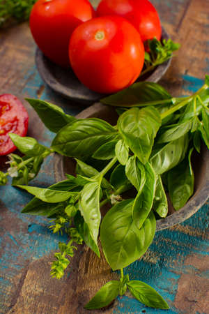 Best Mediterranean herb for cooking - fresh green basil with sweet, strong aroma and flavour on wooden backgroundの写真素材
