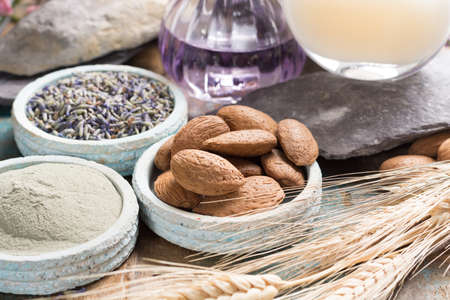Nature cosmetics, handmade preparation with essential oils and ancient minerals of  parfums, skincare, creams, soaps from fresh and dried lavender flowers, roses, wheat, almond nuts, green clay powder in French artisanal boutique home styleの写真素材