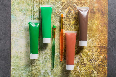 Colours of the nature - mix of green and brown - home or office interieur design concept, tubes with acrylic paint and  brush, close upの写真素材