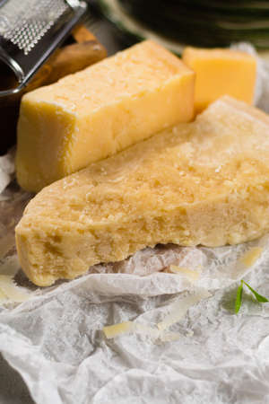 Aged parmesan cheese on the olive wooden board, italian foodの写真素材