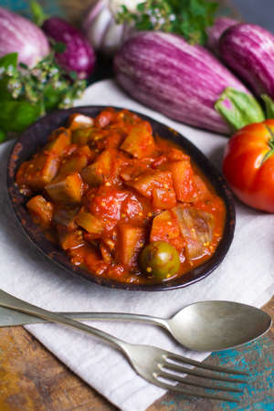 Best italian food - sicilian caponata with eggplants, tomatoes, onion, garlic and herbs, healthy vegetarian foodの写真素材