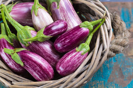Vegetarian menu template - small fresh eggplants on wooden table copy space, healthy foodの写真素材