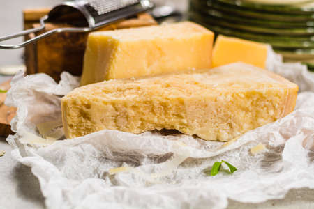 Aged parmesan cheese on the olive wooden board, italian foodの写真素材