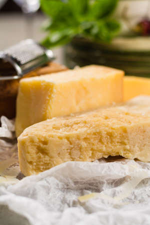 Aged parmesan cheese on the olive wooden board, italian foodの写真素材