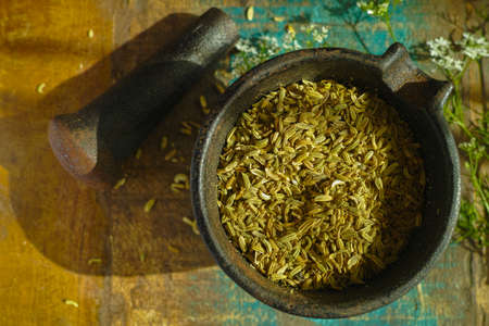 Cumin seeds in old indian cast iron mortarの写真素材