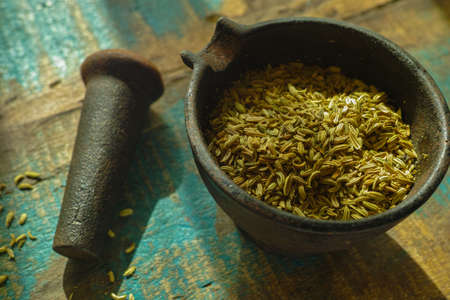 Cumin seeds in old indian cast iron mortarの写真素材