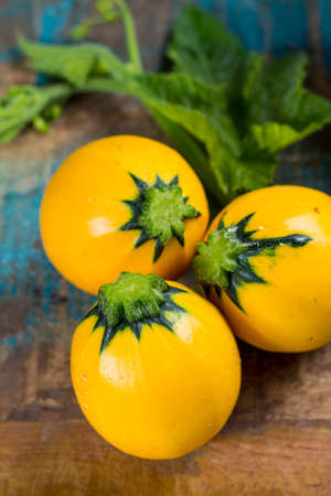 Round yellow courgette or zucchini, on wooden background, close up, healthy foodの写真素材