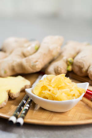 Red bowl of delicious fresh pickled sushi ginger, ready to eat, asian food conceptの写真素材