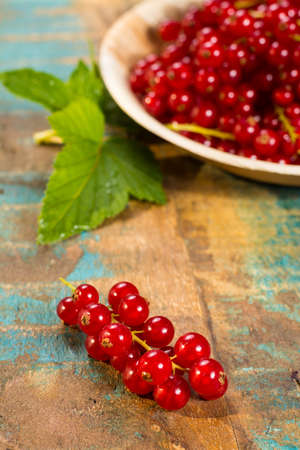 Fresh ripe red currant berries on the table, healthy foodの写真素材