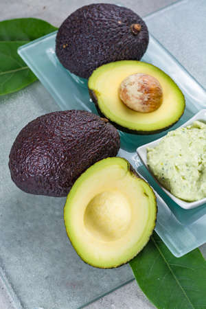 Avocado skin & hair care home spa, ripe avocados and bowl with homemade fresh avocado mask, nature laboratoryの写真素材