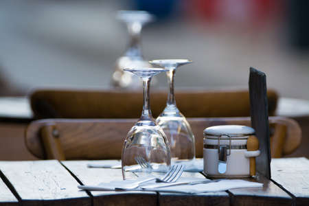 Empty wine glasses on the table served for lunch, dinner in cafe, restaurant outside or on terrase, vacation timeの写真素材
