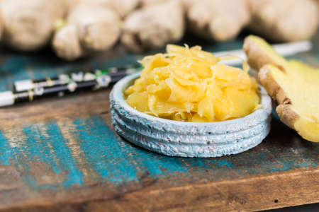 Red bowl of delicious fresh pickled sushi ginger, ready to eat, asian food conceptの写真素材