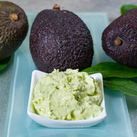 Avocado skin & hair care home spa, ripe avocados and bowl with homemade fresh avocado mask, nature laboratoryの写真素材
