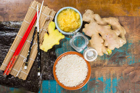 Asian food background. Sushi and rolls preparation. Making sushi at home traditional sushi ingredients - ginger, rice, vinager,の写真素材