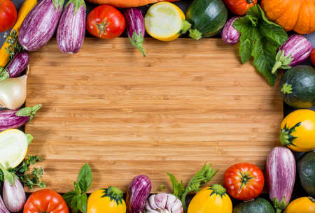 Bamboe plate with copy space, restautant concept with fresh colorful organic vegetables - round courgette, small eggplants, tomatoes, diet concept, Italian and French food, healthy food. Menu temptale.の写真素材