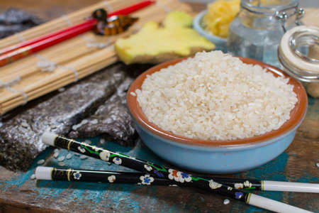 Asian food background. Sushi and rolls preparation. Making sushi at home traditional sushi ingredients - ginger, rice, vinager,の写真素材