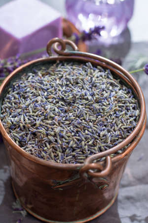 Dried and fresh lavender flowers, ingredients for aroma spa treathment and bodycare for women in old copper bucketの写真素材