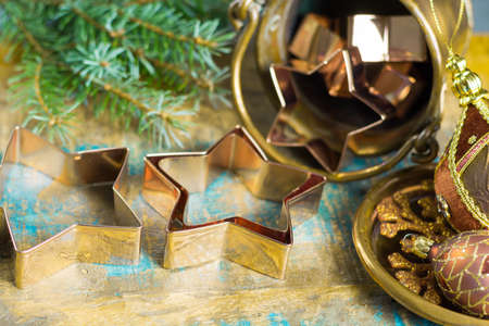 Golden metal cutting forms for christmas star cookies, biscuits, brass or copper with christmas decorationsの写真素材