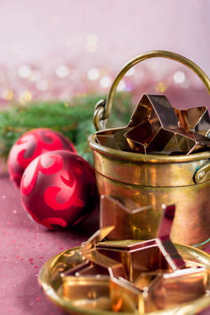 Golden metal cutting forms for christmas star cookies, biscuits, brass or copper with christmas decorationsの写真素材