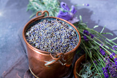 Dried and fresh lavender flowers, ingredients for aroma spa treathment and bodycare for women in old copper bucketの写真素材